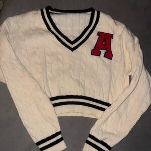 Ivory Cable Knit V-Neck Sweater with Black Trim & Red Patch A